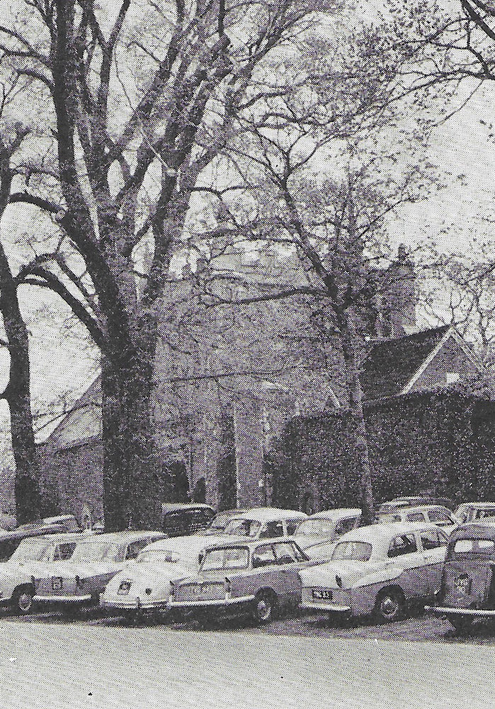 Fig. 155 Every accessible space is taken up by cars. The Gate to the Bishop's Palace.
