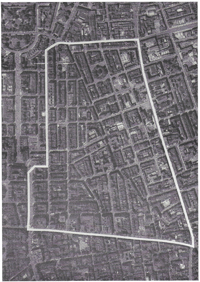 Fig.163 The study area from the air. The great difficulty which the present arrangement of streets and buildings presents for traffic circulation is self-evident from this photograph. Densely-developed sites, with virtually no internal space for parking, are served by a complex awkwardly-arranged network of narrow streets with a mass of intersections each of which is an obstruction to movement.