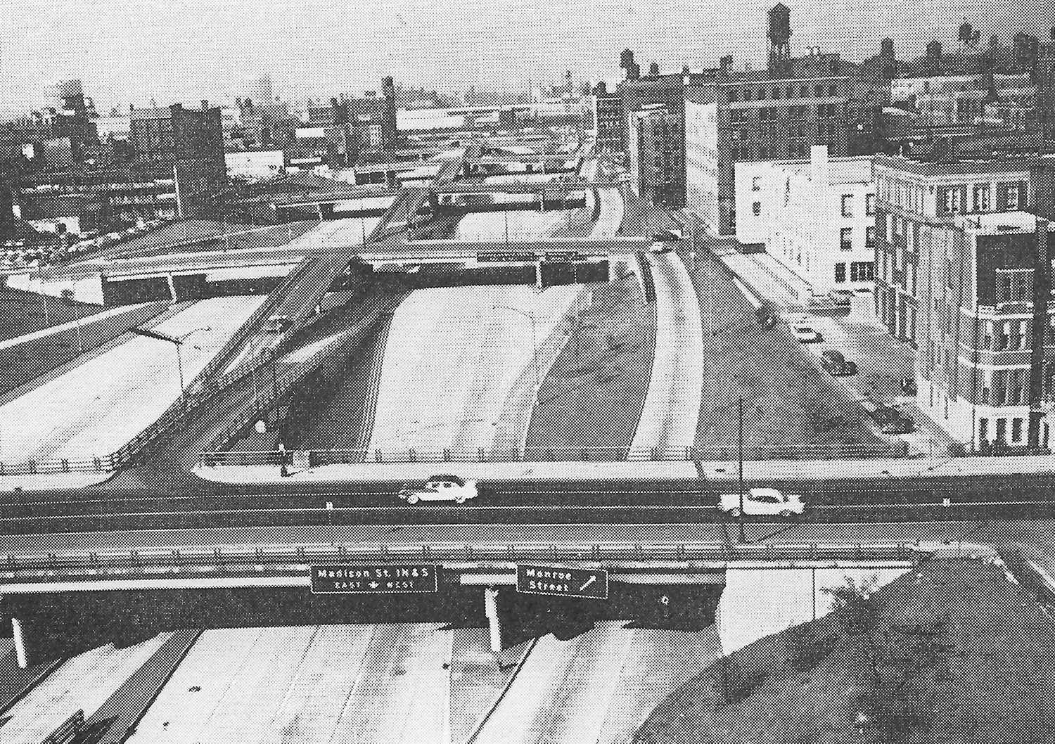 Fig. 239 Chicago. A depressed freeway skirting the downtown area. Note the great scale of the construction, how the local roads flow over the freeway, and the frequency of the access ramps which are about as close as could reasonably be contrived. The down-grade of the ‘on’ ramp assists acceleration, and the up-grade of the 'off' ramp helps deceleration.